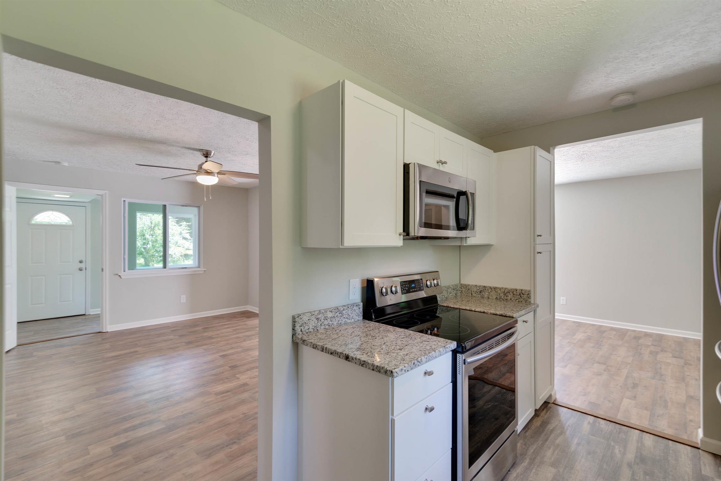 456 Boiling Springs Road Portland, TN 37148 - Photo 6 of 28 a kitchen with granite countertop a stove and a sink