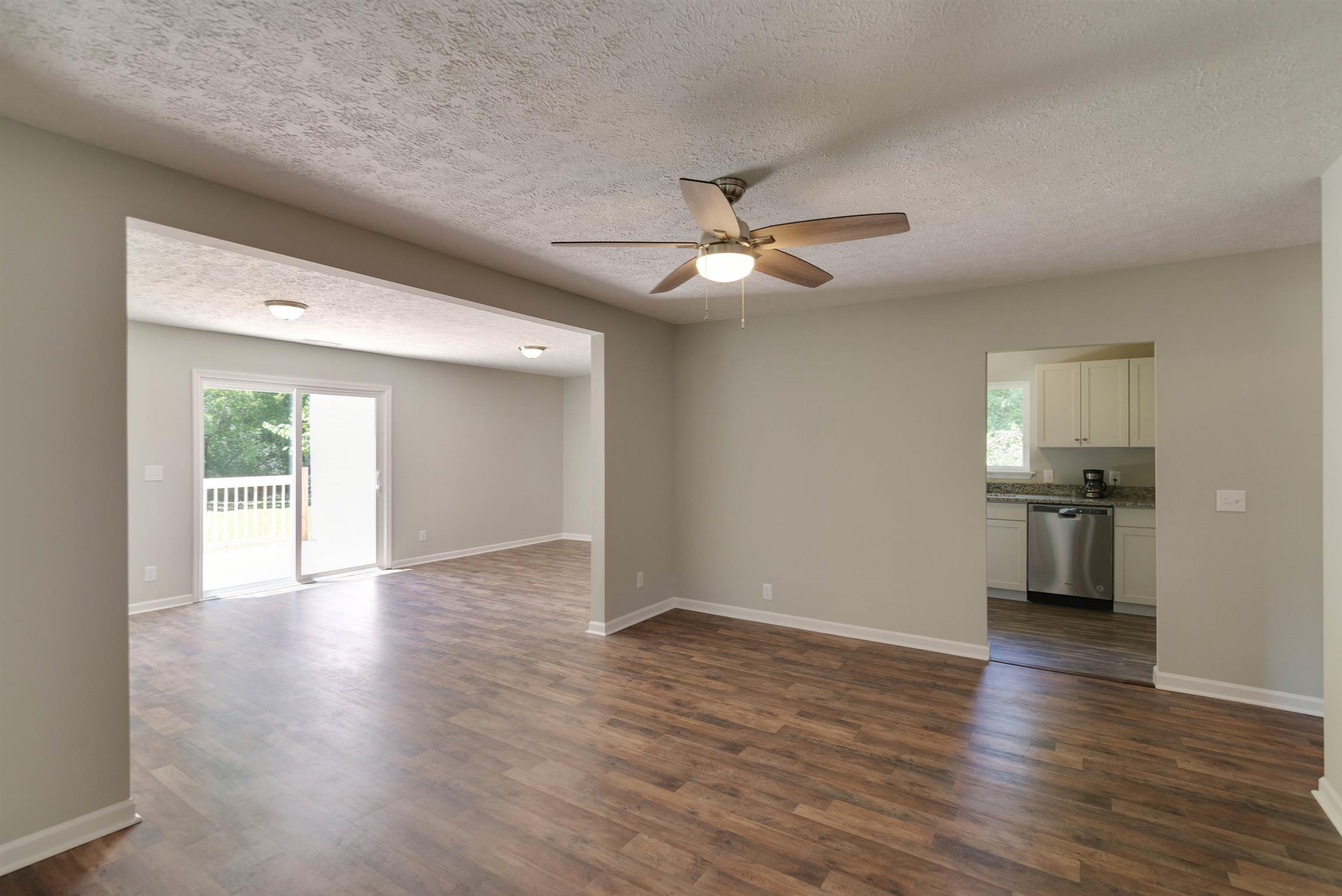456 Boiling Springs Road Portland, TN 37148 - Photo 7 of 28 a view of an empty room with a window and wooden floor