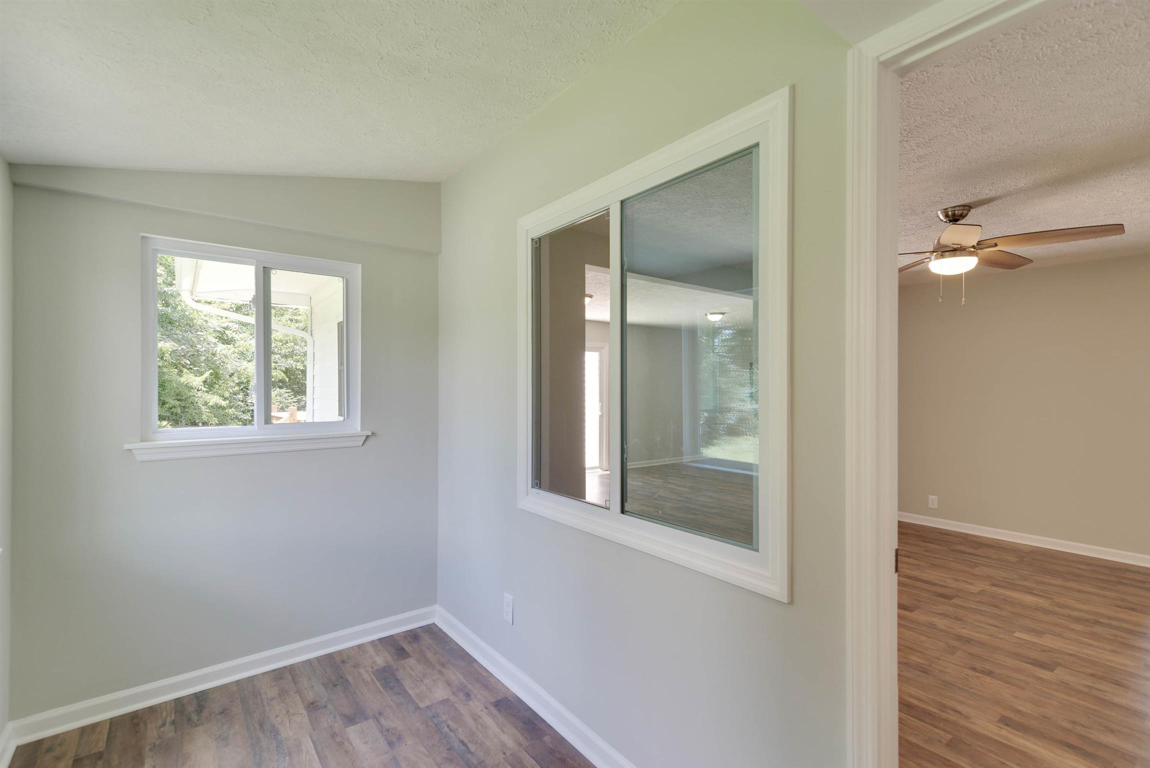 456 Boiling Springs Road Portland, TN 37148 - Photo 9 of 28 a view of an empty room with wooden floor and a window