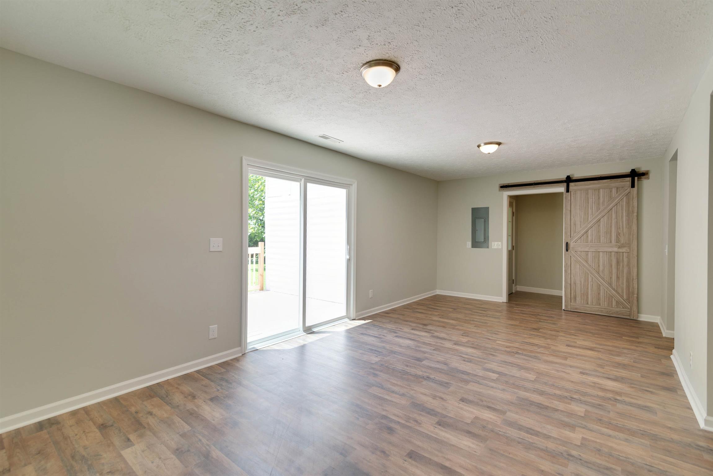 456 Boiling Springs Road Portland, TN 37148 - Photo 10 of 28 a view of an empty room with wooden floor and a window
