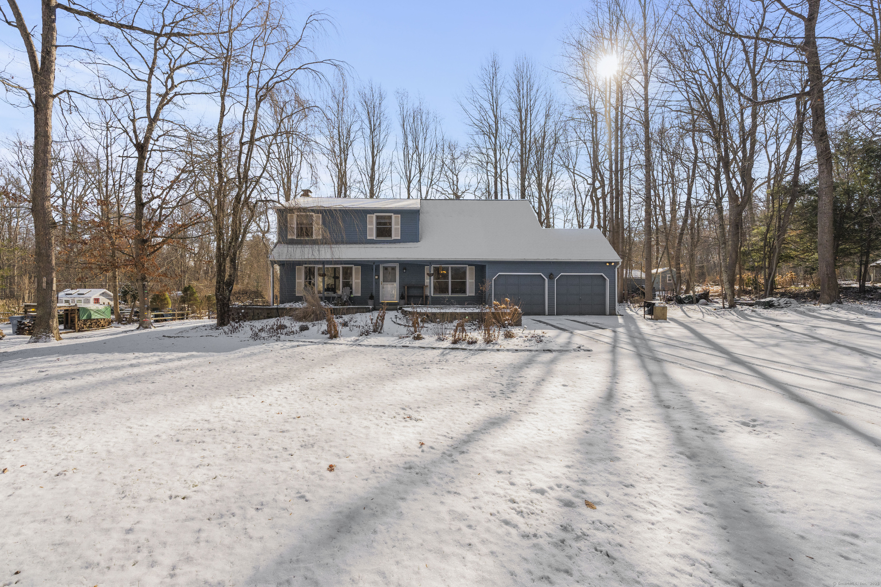 7 Whippoorwill Drive Ledyard, CT 06335 - Photo 1 of 1 a front view of a house with a yard covered with snow and trees