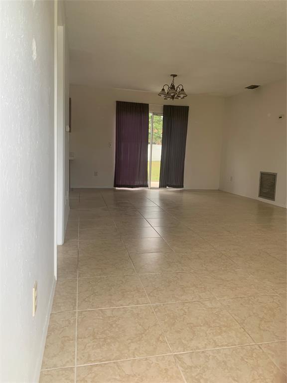 2273 Southeast Merrill Road Port St. Lucie, FL 34952 - Photo 2 of 8 a view of an empty room with wooden floor and windows