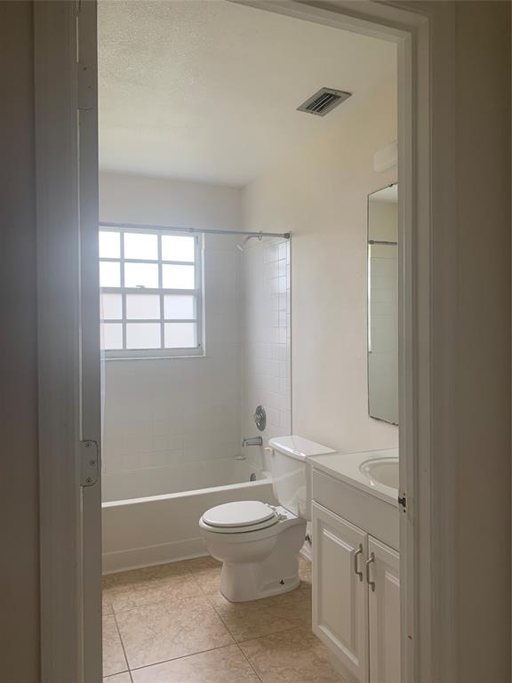 2273 Southeast Merrill Road Port St. Lucie, FL 34952 - Photo 5 of 8 a bathroom with a toilet a sink and a window