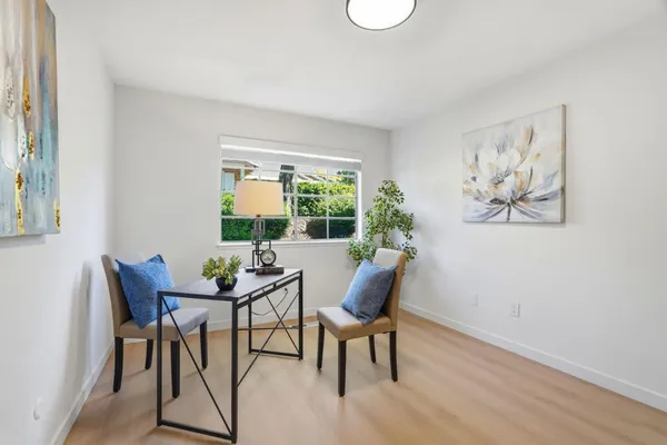 a dining room with furniture and window
