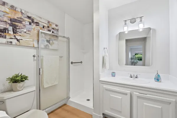 a bathroom with a sink vanity granite and a mirror
