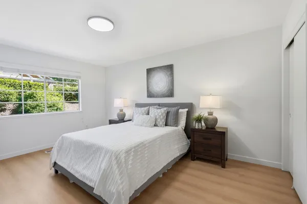 a bedroom with a bed and a night stand