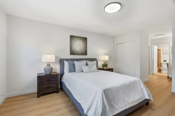 a bedroom with a bed and a lamp