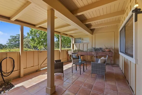 a view of a patio with a table and chairs
