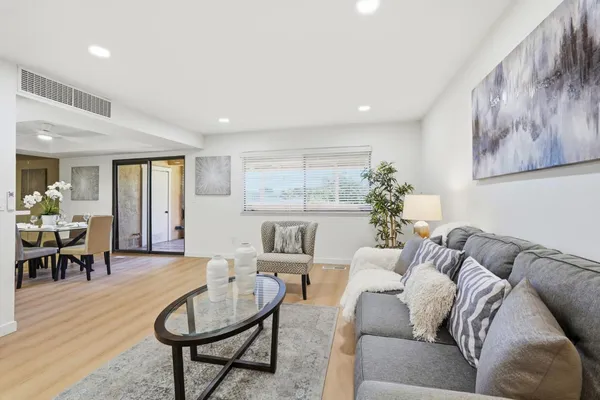 a living room with furniture and wooden floor