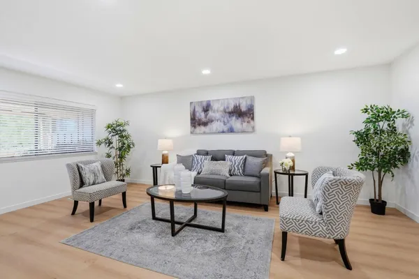 a living room with furniture and a potted plant