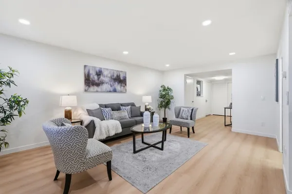 a living room with furniture and wooden floor