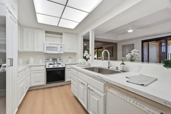 a kitchen with stainless steel appliances granite countertop a sink and cabinets