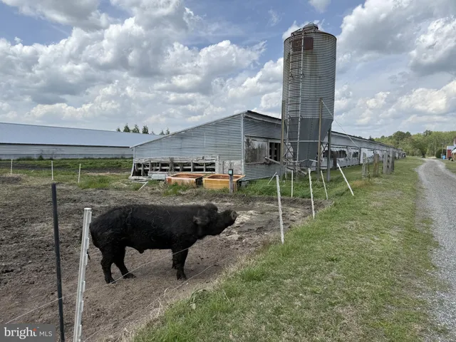 a view of a house with yard and sitting area