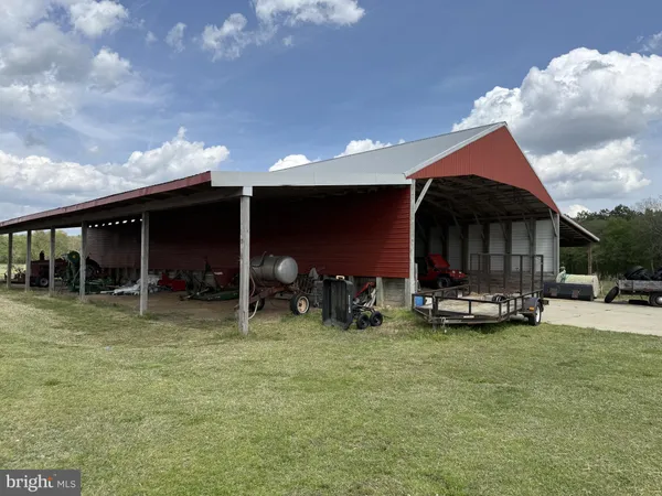a view of a house with yard and sitting area