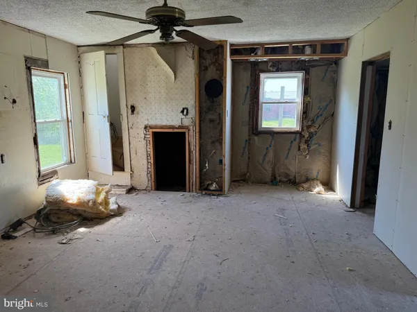 an empty room with windows and closet