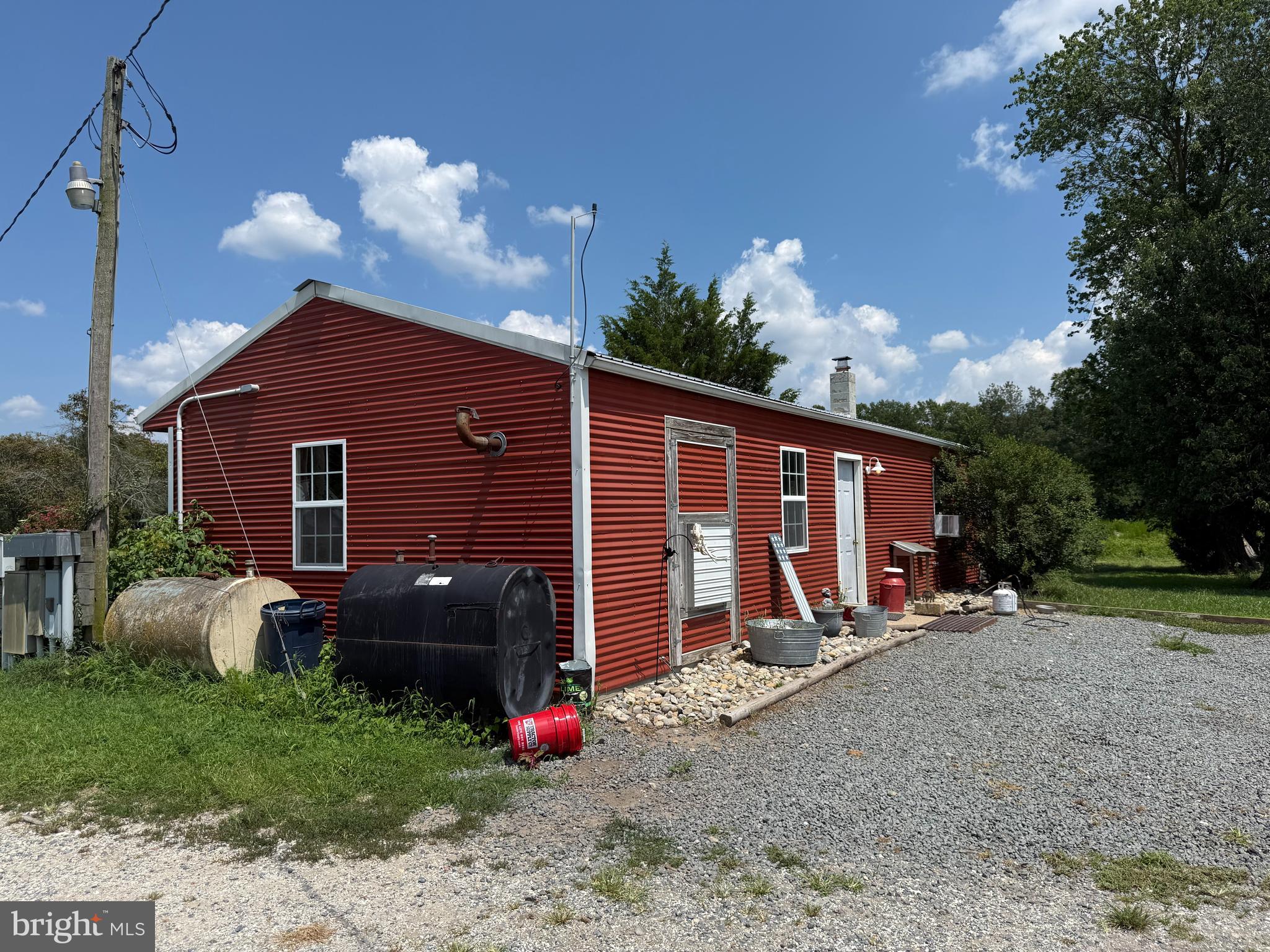 36555 Sheppards Crossing Road Willards, MD 21874 - Photo 43 of 47 a view of a backyard with potted plants and a large tree