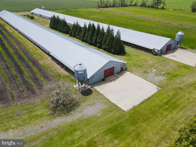 an aerial view of a house with a garden and lake view
