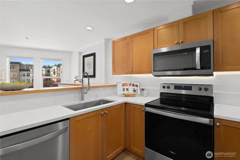 a kitchen with stainless steel appliances a stove sink and microwave