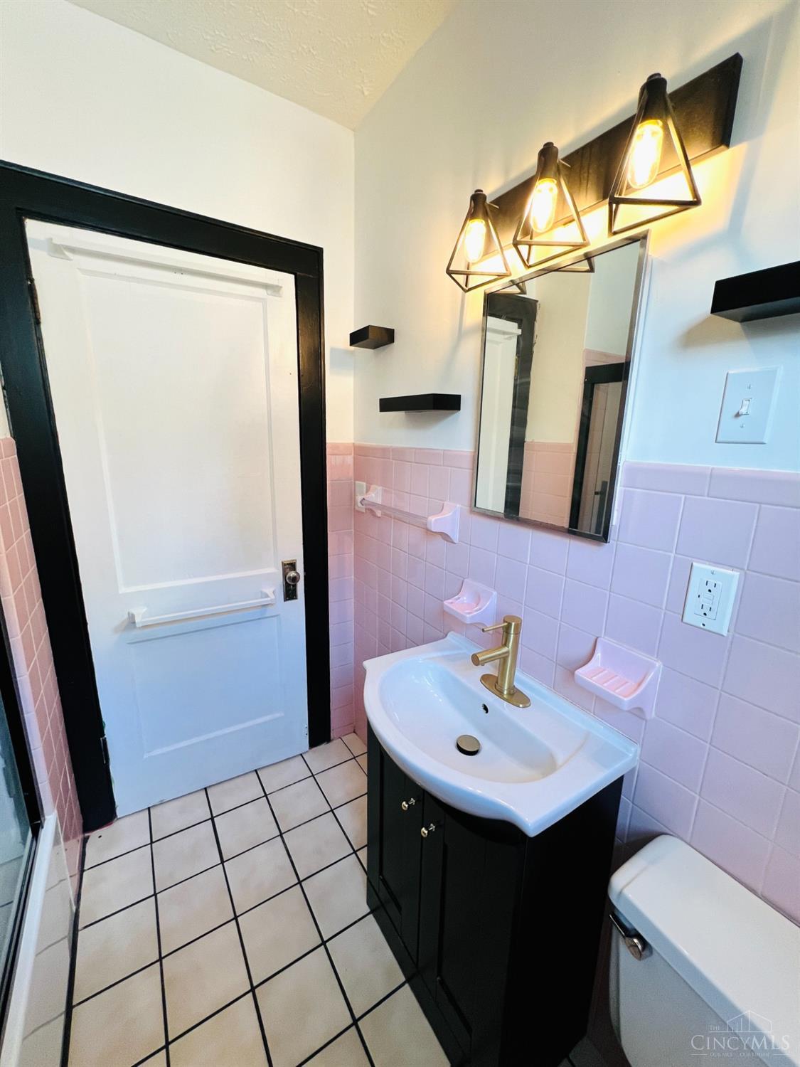 3904 Watterson Road Cincinnati, OH 45227 - Photo 8 of 19 Full bath has been carefully restored to maintain its original charm. New fixtures complement the space.