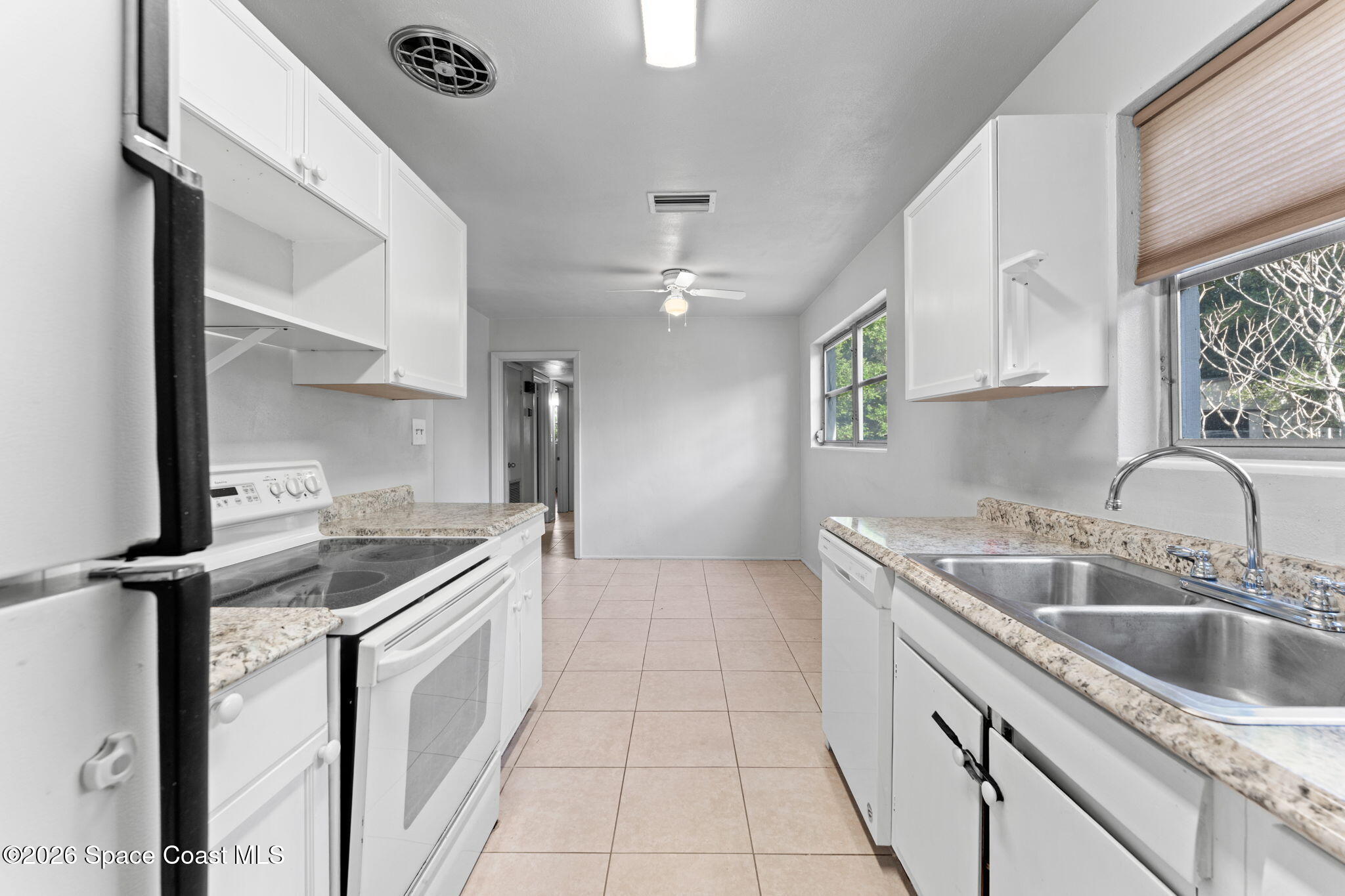 1042 Azalea Lane Cocoa, FL 32922 - Photo 12 of 26 a kitchen with a sink stove and cabinets