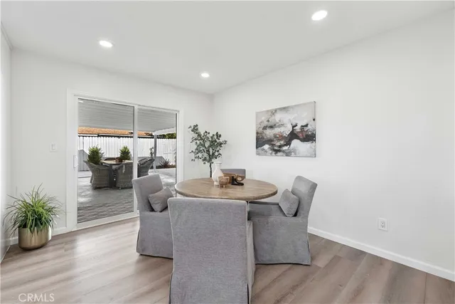 a dining room with furniture and wooden floor