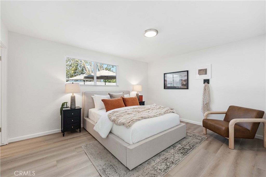 727 North Burney Street Rialto, CA 92376 - Photo 15 of 40 a bedroom with a bed and a couch