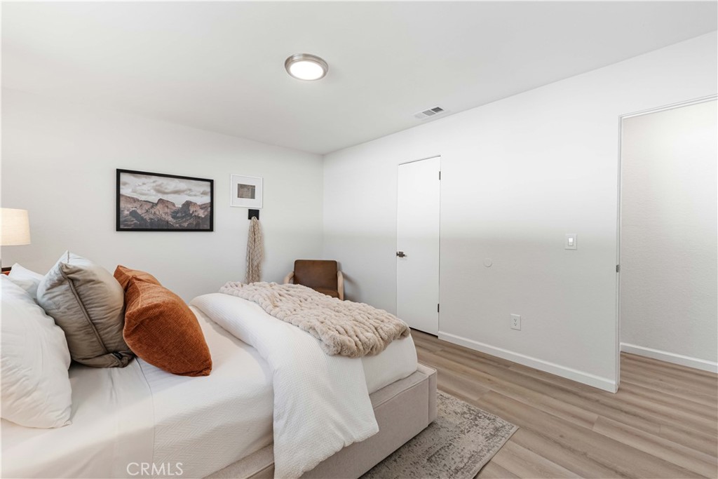 727 North Burney Street Rialto, CA 92376 - Photo 17 of 40 a bedroom with a bed and wooden floor