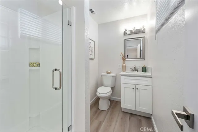 a bathroom with a toilet sink and shower