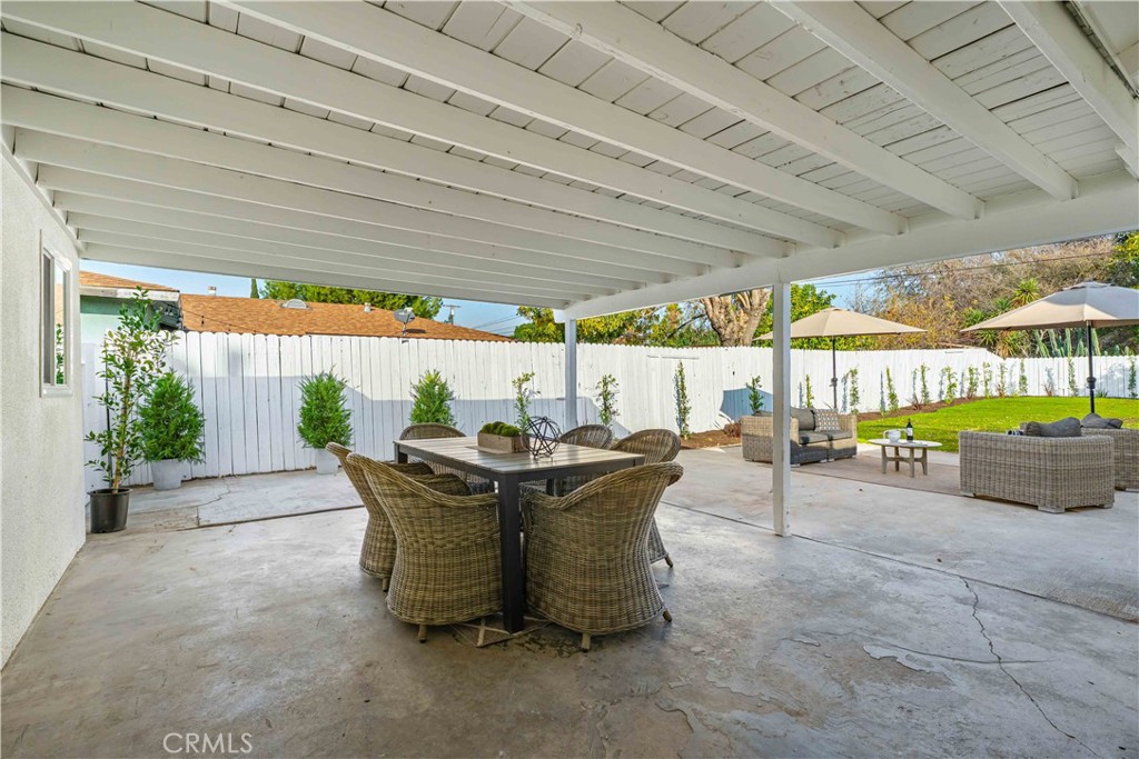 727 North Burney Street Rialto, CA 92376 - Photo 25 of 40 a view of a patio with a table chairs and a backyard