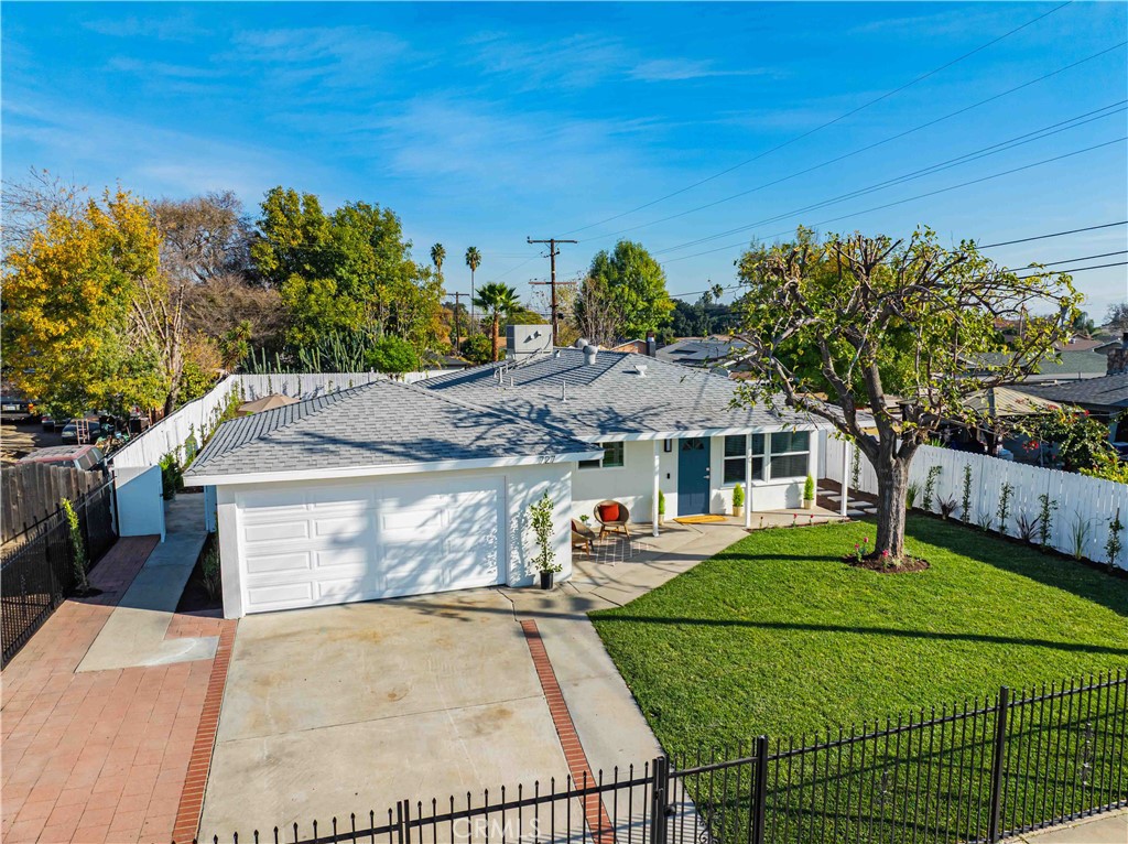 727 North Burney Street Rialto, CA 92376 - Photo 32 of 40 a view of a white house with a yard table and chairs