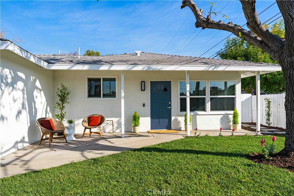 727 North Burney Street Rialto, CA 92376 - Photo 4 of 40 a view of a patio with table and chairs potted plants and large tree