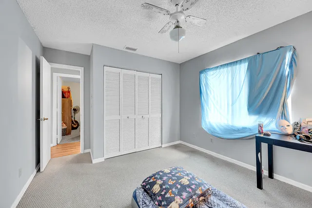 a bedroom with furniture and a window