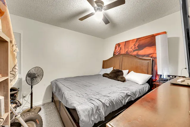 a bedroom with a bed and painting on the wall