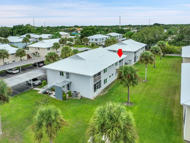 an aerial view of a house with a yard and lake view