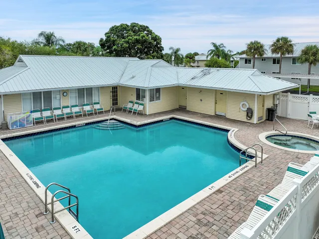 an aerial view of a house with swimming pool and deck
