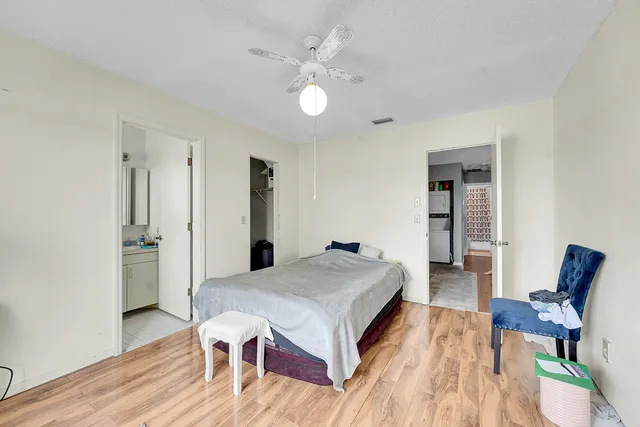 a spacious bedroom with a bed and a table in it