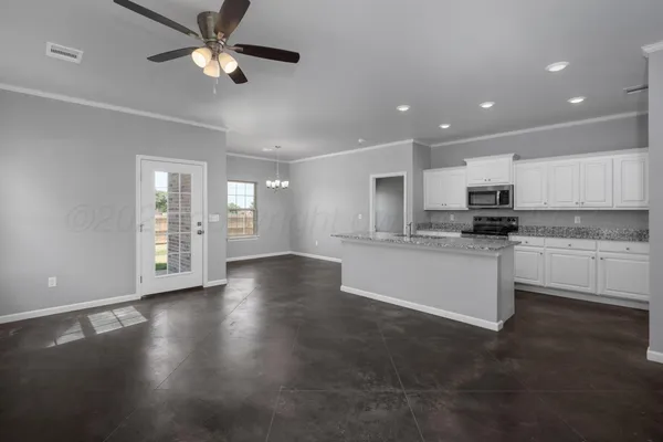 a view of kitchen with refrigerator and window