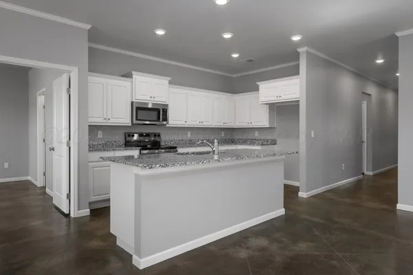 a kitchen with stainless steel appliances granite countertop a refrigerator stove microwave and sink