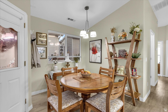 2990 East Riverside Drive, Unit 166 St. George, UT 84790 - Photo 10 of 22 Dining space with a chandelier, light wood-style floors, and lofted ceiling