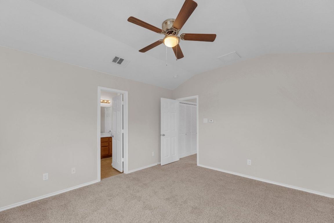 14815 Avery Ranch Boulevard, Unit 403/4B Austin, TX 78717 - Photo 17 of 38 an empty room with closet and ceiling fan