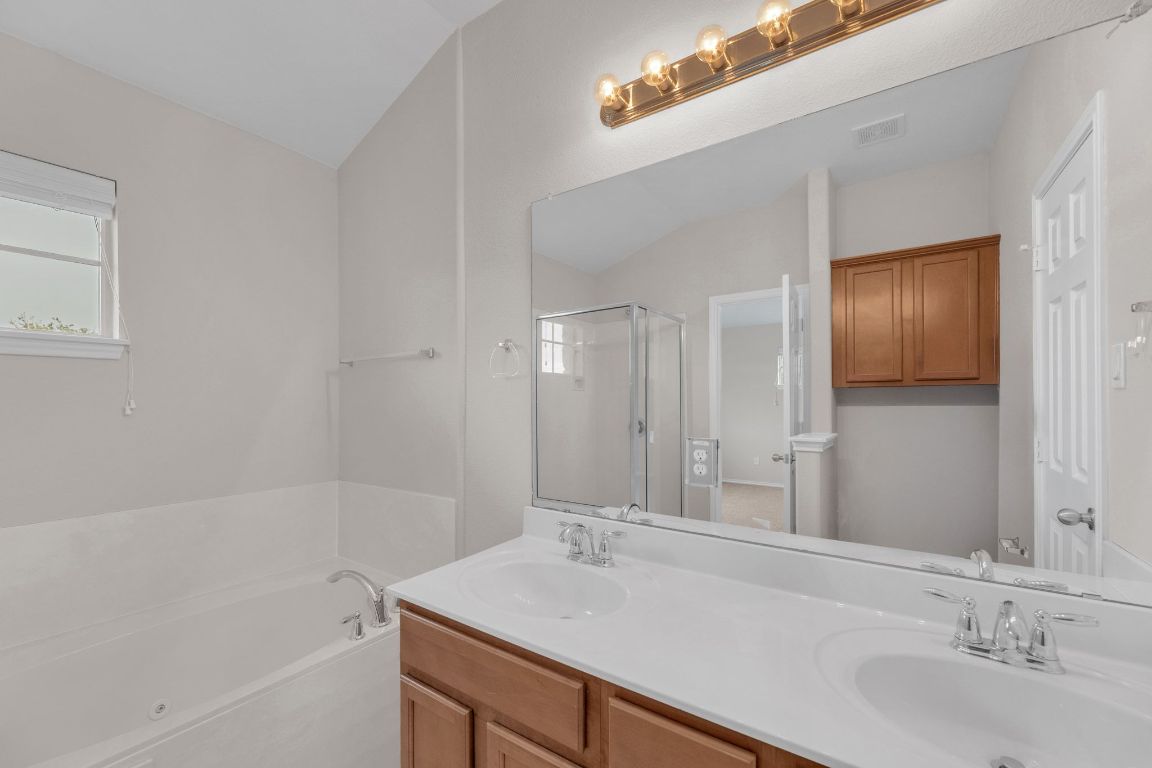 14815 Avery Ranch Boulevard, Unit 403/4B Austin, TX 78717 - Photo 19 of 38 a bathroom with a sink and a bathtub