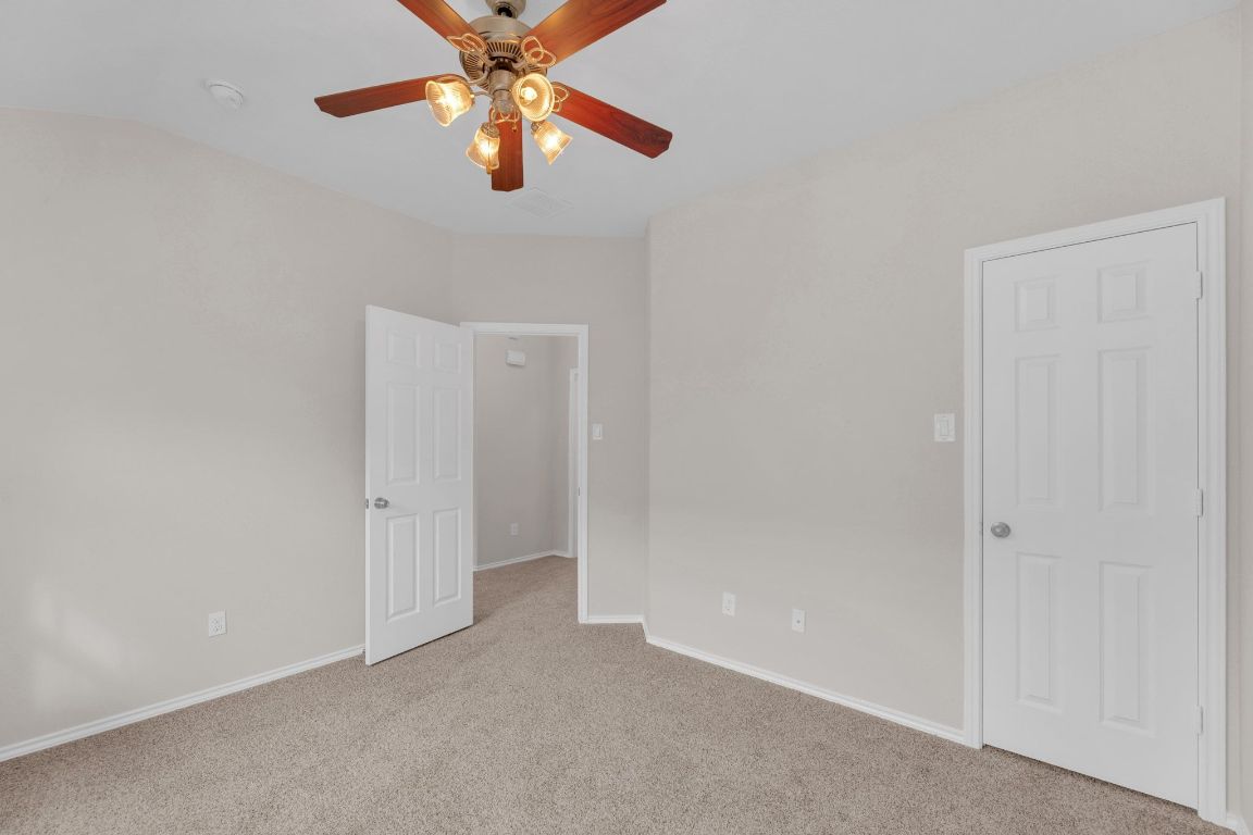 14815 Avery Ranch Boulevard, Unit 403/4B Austin, TX 78717 - Photo 27 of 38 an empty room with chandelier fan
