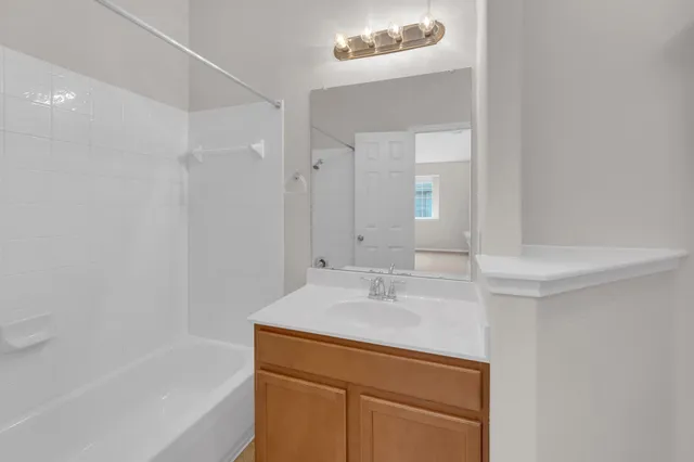 a bathroom with a sink a shower and a mirror