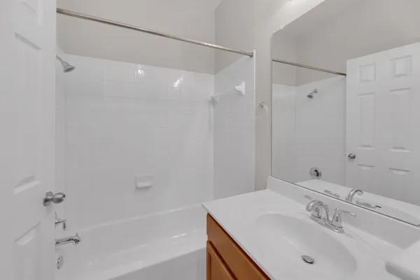 a bathroom with a sink shower and a mirror