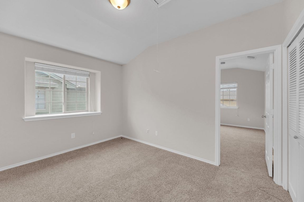 14815 Avery Ranch Boulevard, Unit 403/4B Austin, TX 78717 - Photo 30 of 38 an empty room with windows and closet
