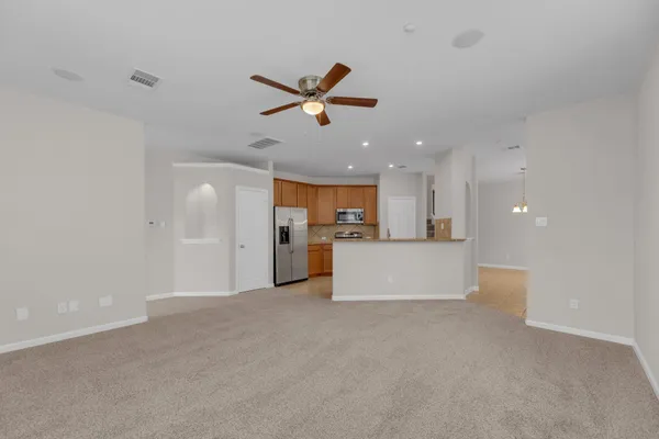 a view of a kitchen with a sink and a refrigerator