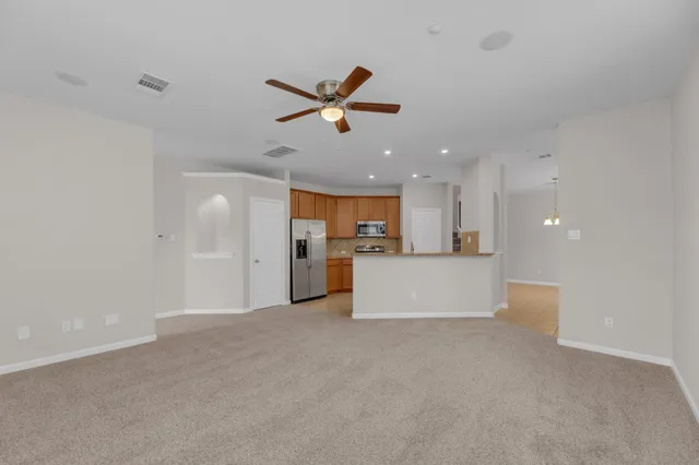 a view of a kitchen with a sink and a refrigerator