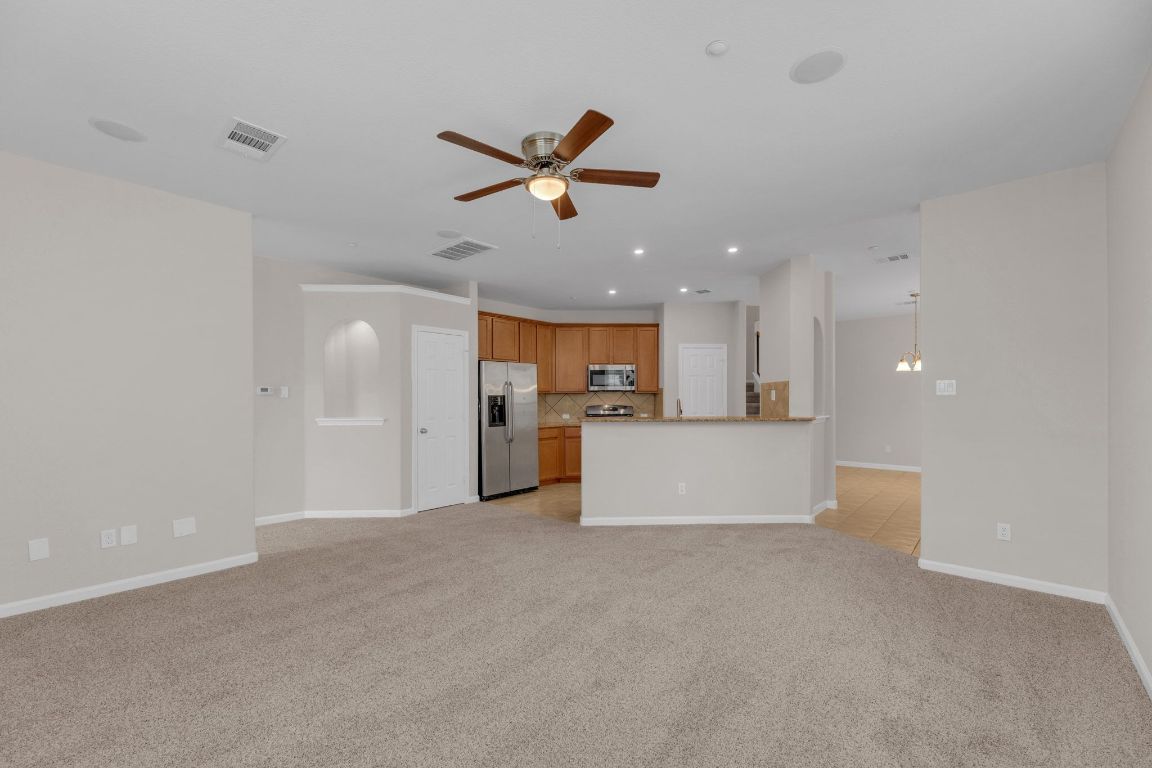 14815 Avery Ranch Boulevard, Unit 403/4B Austin, TX 78717 - Photo 6 of 38 a view of a kitchen with a sink and a refrigerator