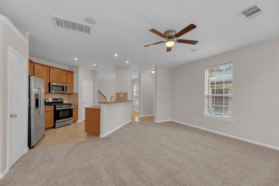 14815 Avery Ranch Boulevard, Unit 403/4B Austin, TX 78717 - Photo 7 of 38 a view of a kitchen with a sink and a refrigerator