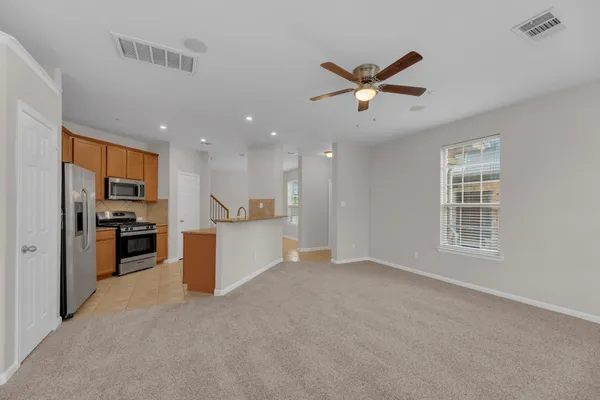a view of a kitchen with a sink and a refrigerator